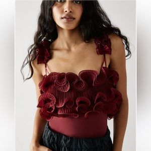 Free People For the Frill of It bodysuit in color wine.